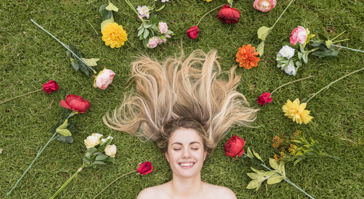 cheerful-lady-lying-grass-flowers