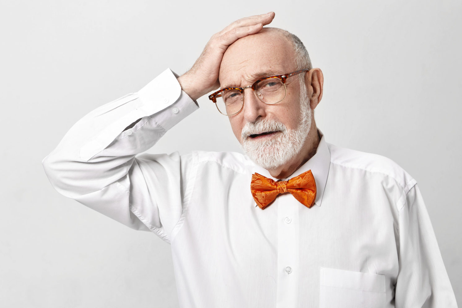 Depressed elderly 65 year old businessman with thick gray beard